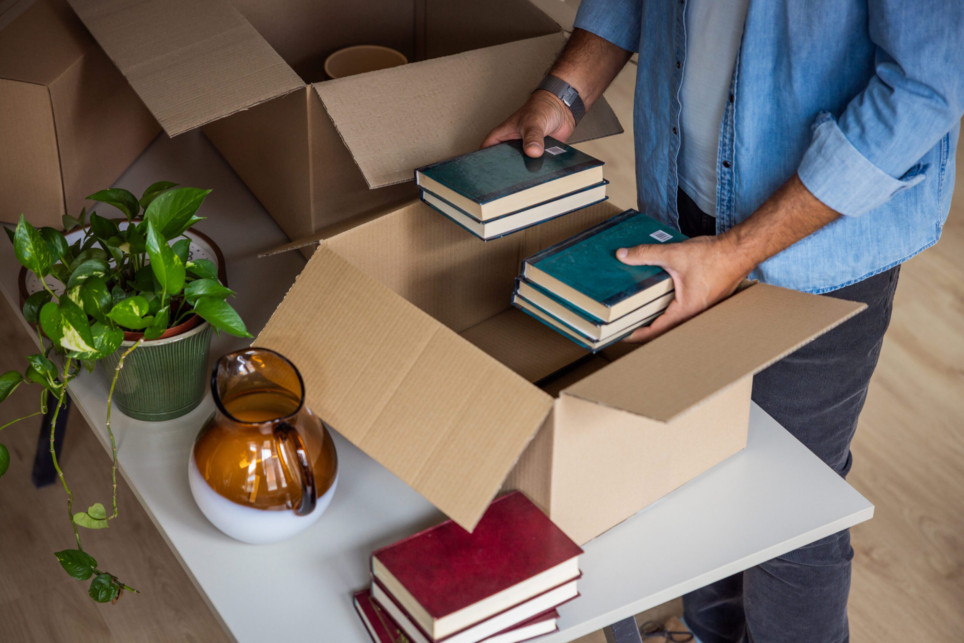 Packing books into cardboard boxes.